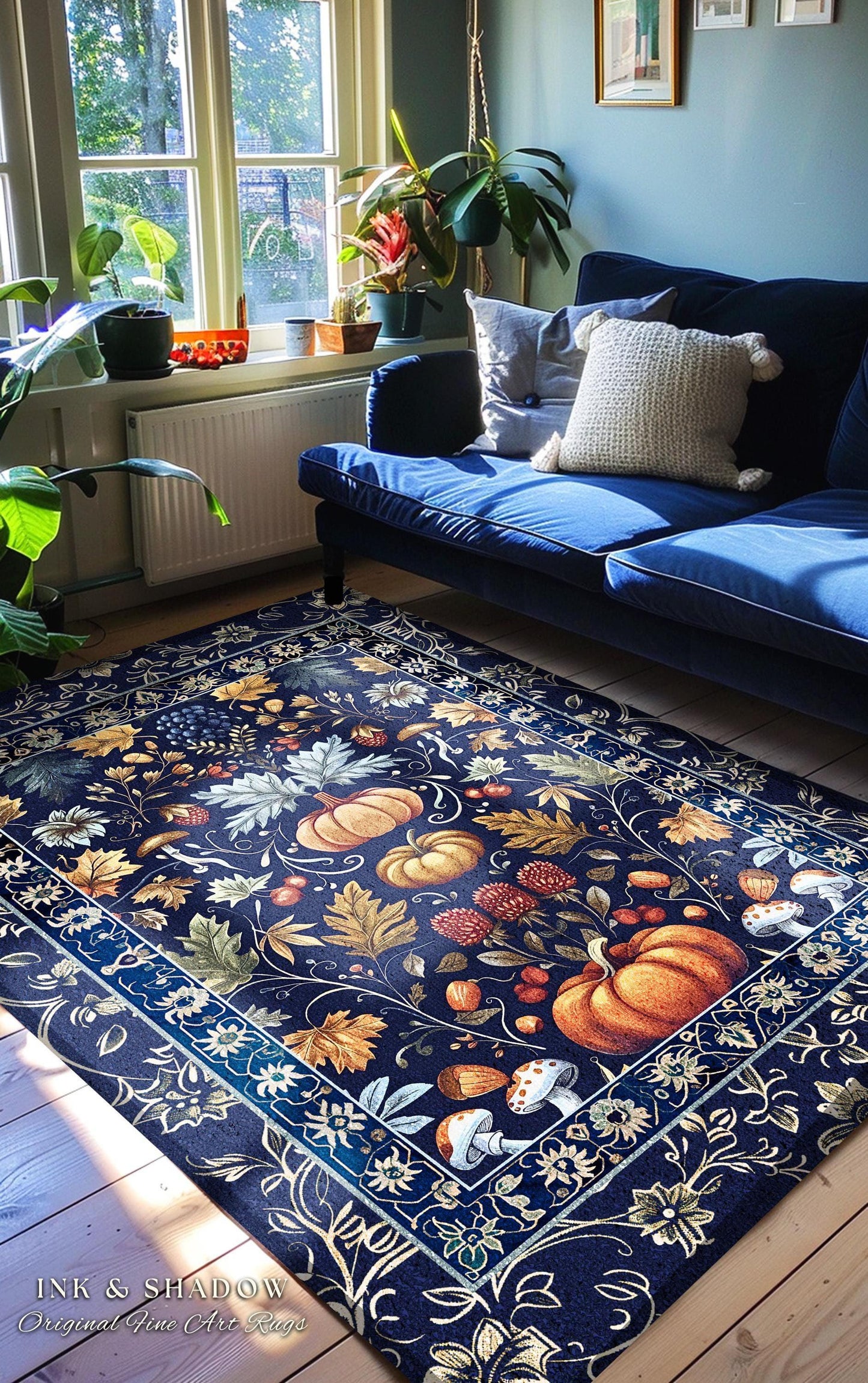 May include: A navy blue rectangular rug with a detailed botanical design featuring pumpkins, leaves, and mushrooms in shades of orange, brown, and cream. The rug has a decorative border and is placed in a living room setting.