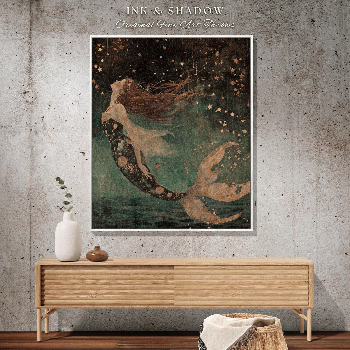 May include: A framed art print featuring a mermaid with flowing red hair and a patterned tail, set against a starry night sky. The artwork is labeled "Ink & Shadow Original Fine Art Throws."