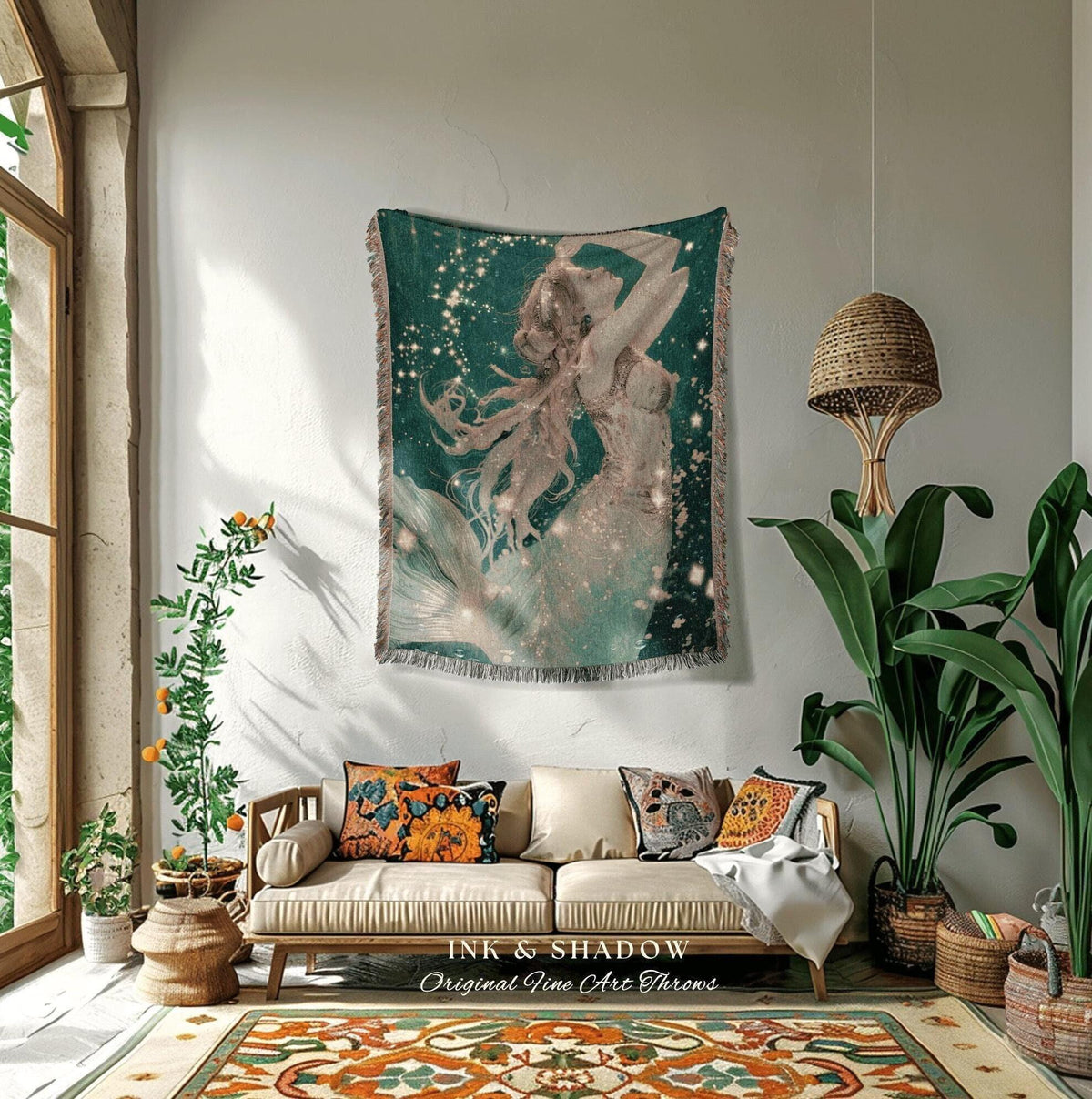 May include: A woven tapestry featuring a mermaid illustration in shades of teal, white, and gold, with the text "INK & SHADOW Original Fine Art Throws". The artwork depicts a mermaid with flowing hair and a shimmering tail, set against a starry background.