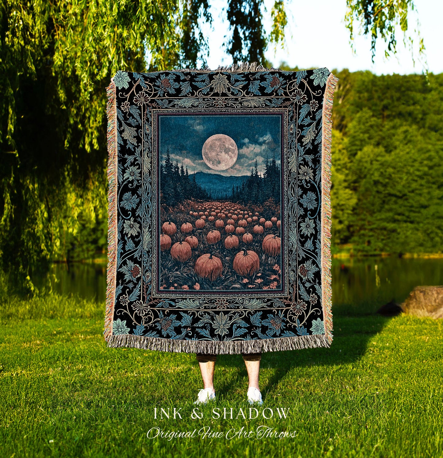 May include: A decorative throw blanket featuring a full moon over a pumpkin field, framed by a floral border. The blanket has a black background with teal and tan accents. The text "INK & SHADOW Original Fine Art Throws" is at the bottom.