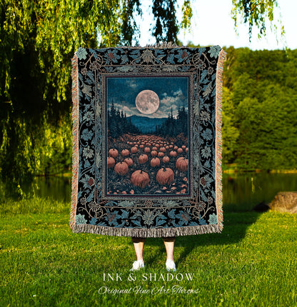 May include: A decorative throw blanket featuring a full moon over a pumpkin field, framed by a floral border. The blanket has a black background with teal and tan accents. The text "INK & SHADOW Original Fine Art Throws" is at the bottom.