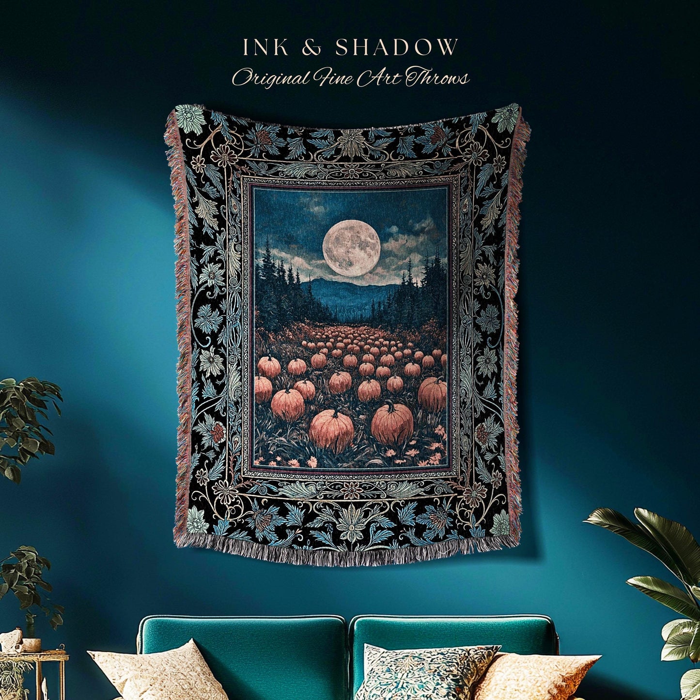 May include: A tapestry throw featuring a full moon over a field of pumpkins, with the text "INK & SHADOW Original Fine Art Throws". The throw has a black border with floral and leaf patterns and a fringed edge. The color palette includes black, blue, and orange.