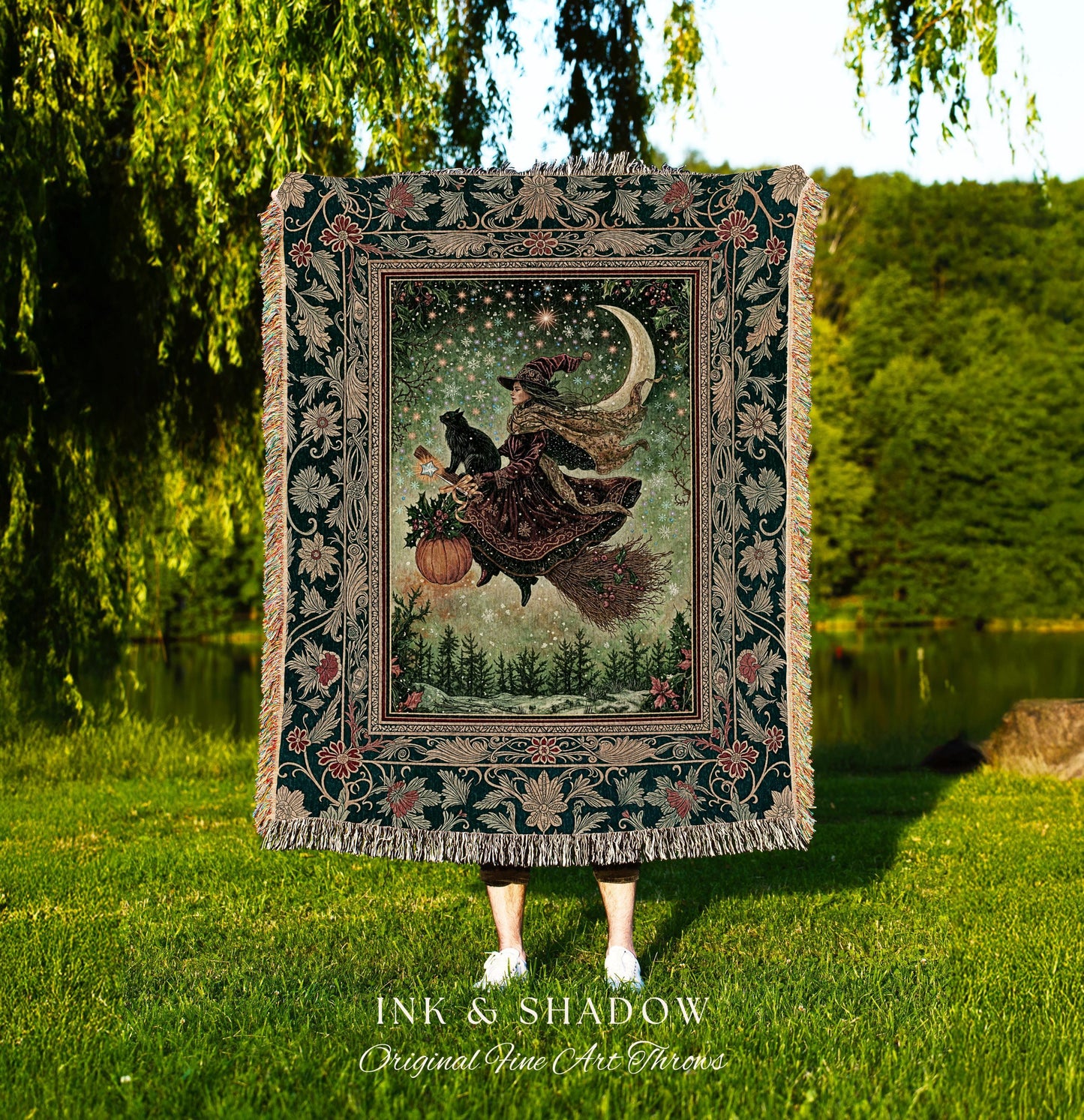 May include: A tapestry throw blanket featuring a witch on a broomstick with a black cat, a pumpkin, and a crescent moon. The throw has a dark green border with floral and leaf patterns, and the text "INK & SHADOW Original Fine Art Throws".