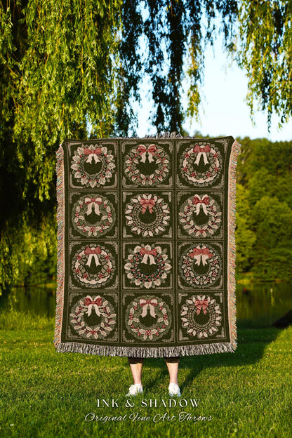 May include: A woven throw blanket with a green background and a repeating pattern of red and green wreaths with bows. The text 'INK & SHADOW Original Fine Art Throws' is at the bottom of the blanket.