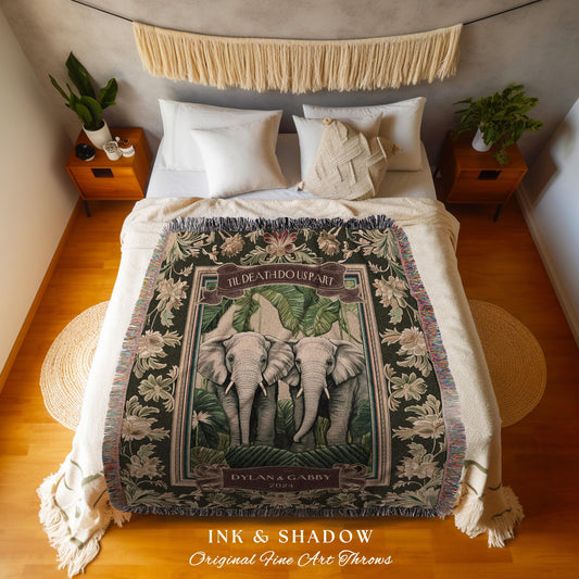 May include: A woven throw blanket featuring a central image of two elephants surrounded by tropical foliage. The blanket has a dark green background with floral accents and the text "TIL DEATH DO US PART" and "DYLAN & GABBY 2024". The bottom of the blanket reads "INK & SHADOW Original Fine Art Throws".