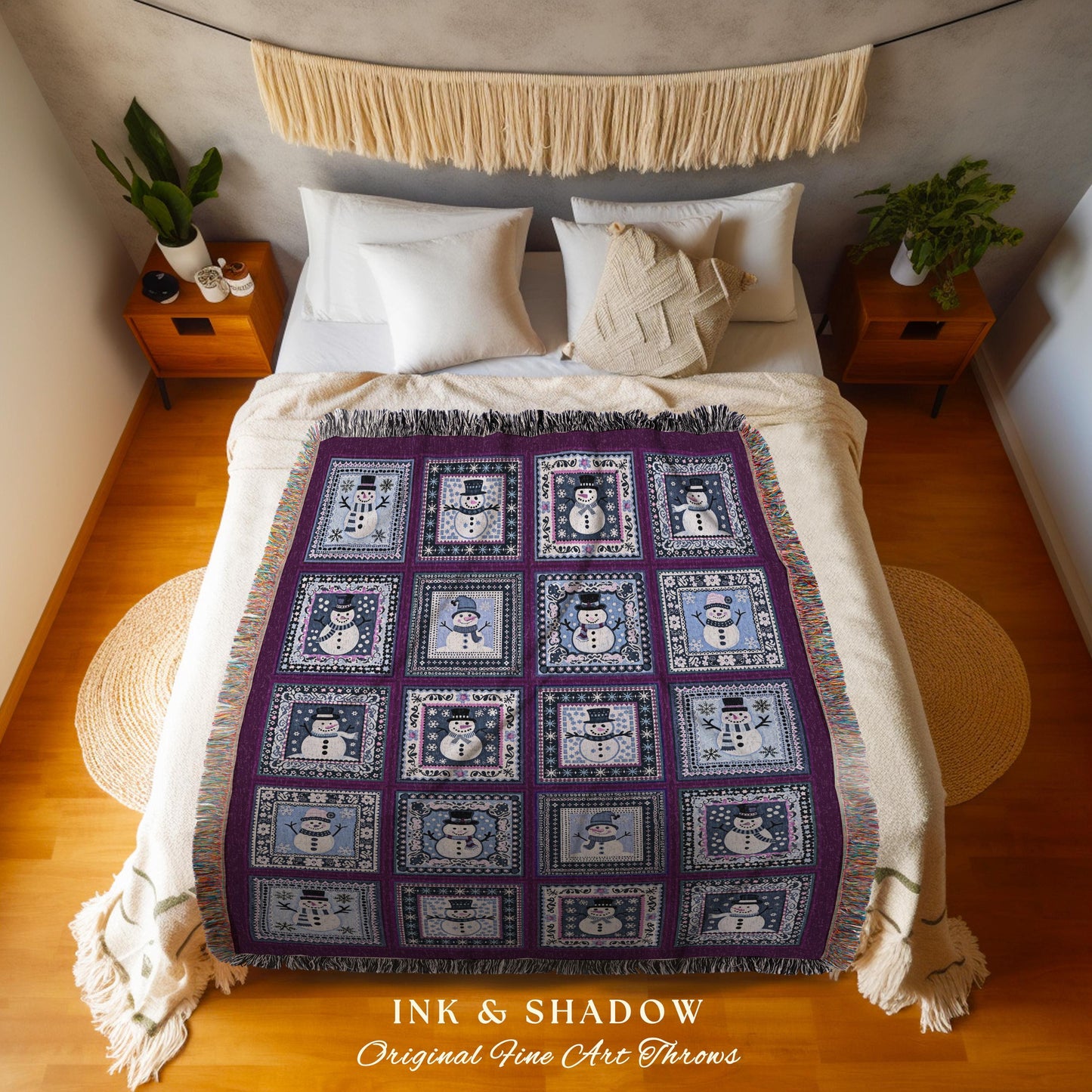 May include: A purple and blue woven throw blanket featuring a repeating pattern of snowmen in square frames. The blanket has a fringed edge and the text "INK & SHADOW Original Fine Art Throws" is visible.
