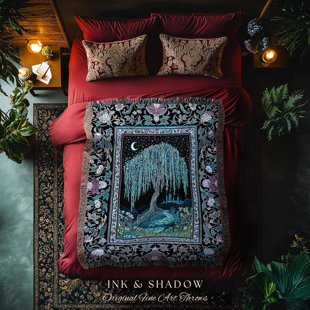 May include: A decorative throw blanket with a black border and a central image of a weeping willow tree under a crescent moon. The blanket is on a red bed with matching pillows. The text "INK & SHADOW Original Fine Art Throws" is at the bottom.