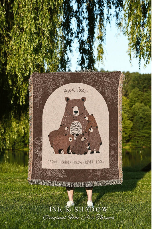 May include: A brown throw blanket featuring a bear family illustration with the words "Papa Bear" at the top. The names Jason, Heather, Drew, River, and Logan are printed below the bears. The blanket has a floral border and fringe.