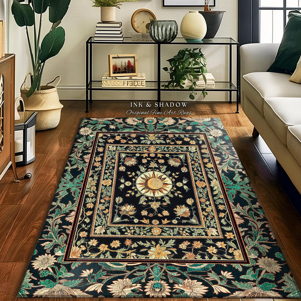 May include: A rectangular area rug with a black background and a floral design. The rug features a central sunburst motif and a border with green, yellow, and red accents. The text "INK & SHADOW Original Fine Art Rugs" is visible.