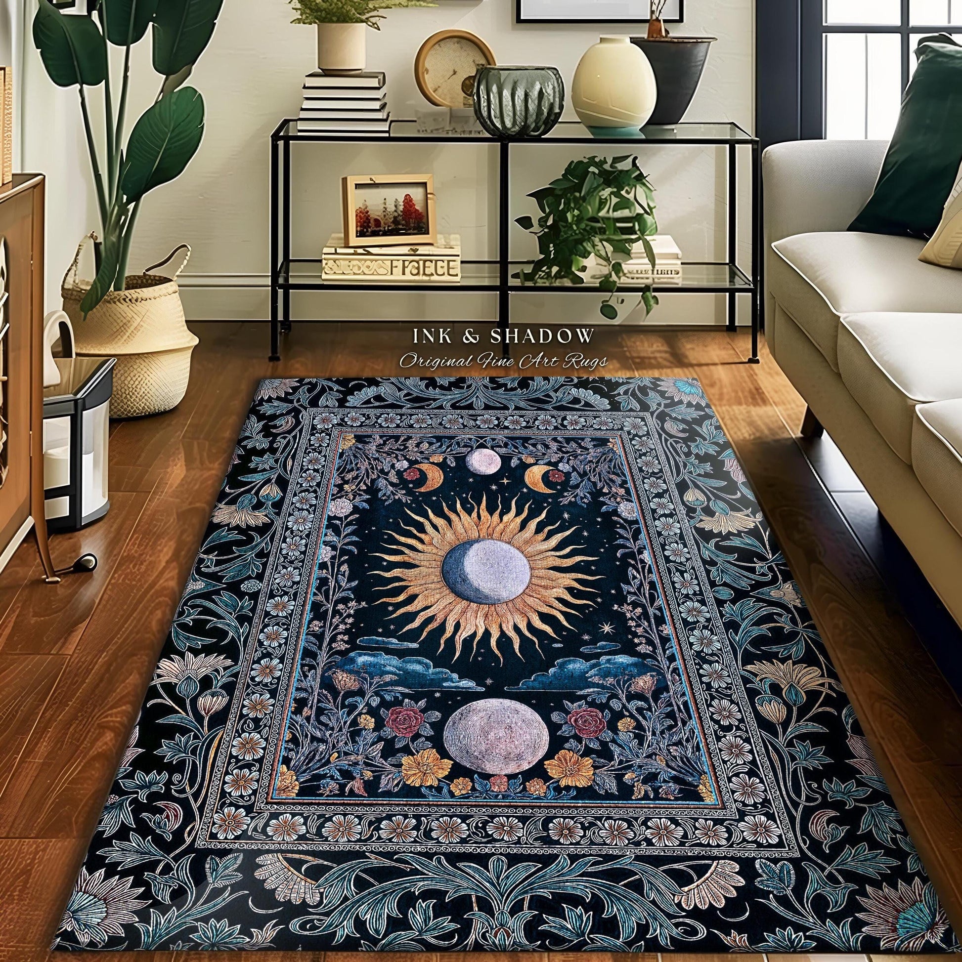 May include: A rectangular area rug with a celestial design. The rug features a central sun and moon motif, surrounded by floral and foliate borders in shades of blue, gold, and pink. The text "INK & SHADOW Original Fine Art Rugs" is visible.