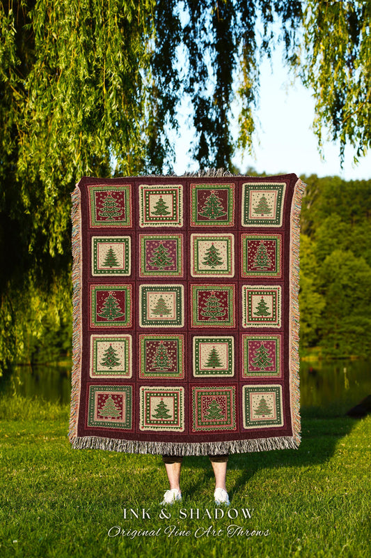 May include: A burgundy throw blanket with a repeating pattern of Christmas trees in squares. The trees are green and red, set against a cream and burgundy background. The blanket has a fringed edge and the text "INK & SHADOW Original Fine Art Throws".