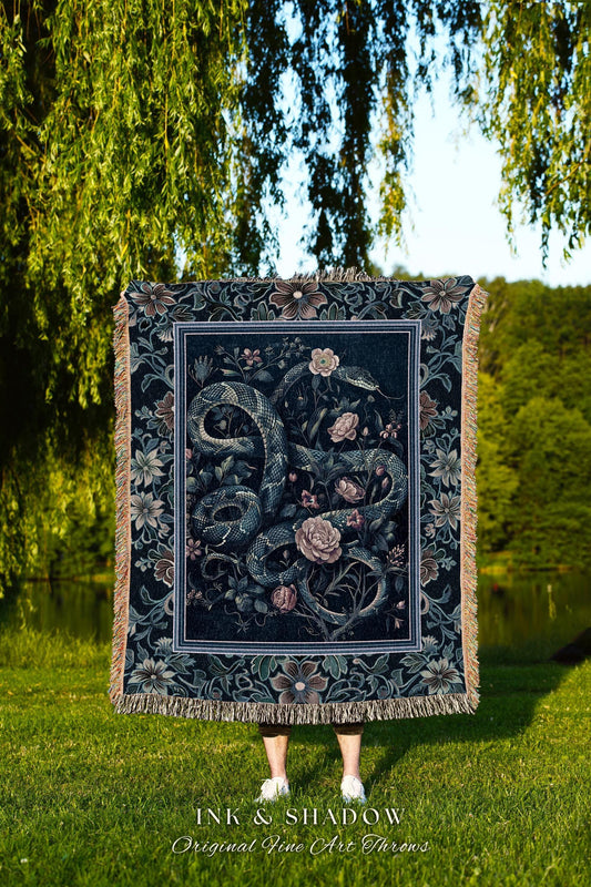 May include: A dark blue throw blanket with a floral and snake design. The blanket has a decorative border and fringe. The text "INK & SHADOW Original Fine Art Throws" is at the bottom of the blanket.