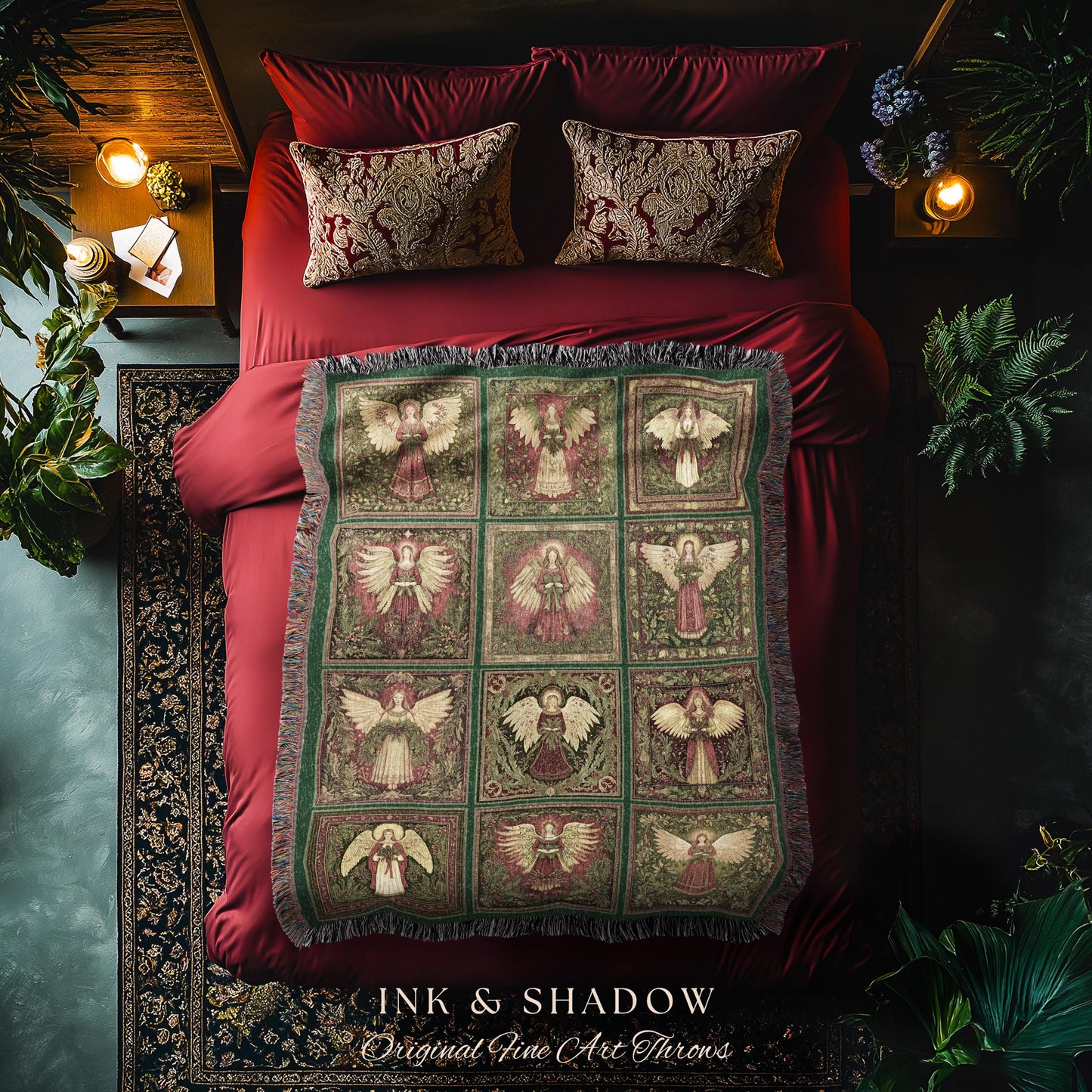 May include: A decorative throw blanket with a repeating pattern of angels in a grid. The blanket features a green border and fringe, with a color palette of red, green, and cream. The text "INK & SHADOW Original Fine Art Throws" is visible at the bottom.