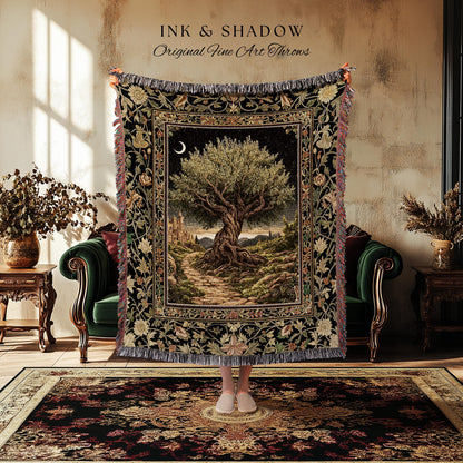 May include: A tapestry throw blanket with a detailed landscape scene featuring a large tree, a path, and a crescent moon. The blanket has a black border with floral and foliage patterns, and the text "INK & SHADOW Original Fine Art Throws".