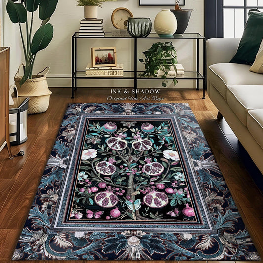 May include: A rectangular area rug with a black central design featuring a tree with pomegranates, surrounded by a floral border in shades of blue, green, and pink. The rug has the text "INK & SHADOW Original Fine Art Rugs".