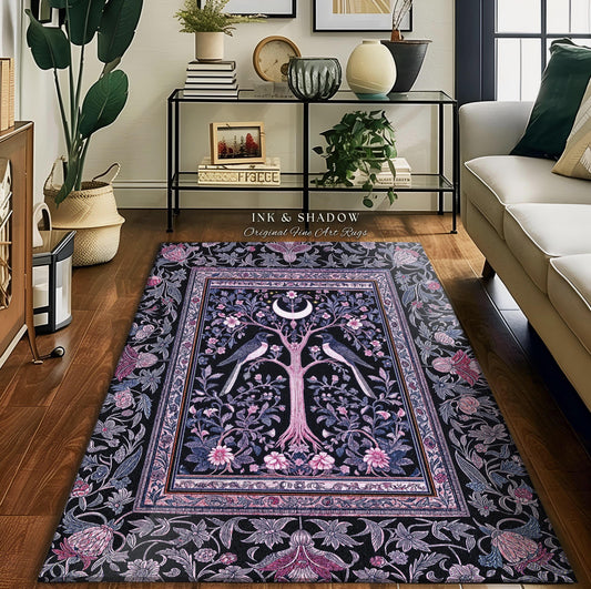 May include: Rectangular black rug with a central design of a tree, birds, and a crescent moon. The rug features a floral border in shades of pink, purple, and blue. The text "INK & SHADOW Original Fine Art Rugs" is visible.