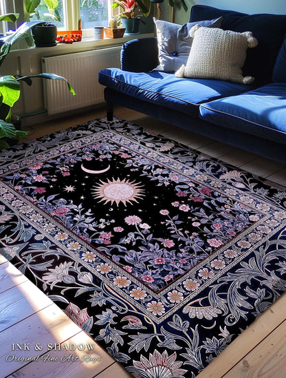 May include: Black area rug with a celestial design featuring a sun, moon, and stars. The rug has a floral border with pink and white flowers. The text "INK & SHADOW Original Fine Art Rugs" is visible in the bottom left corner.