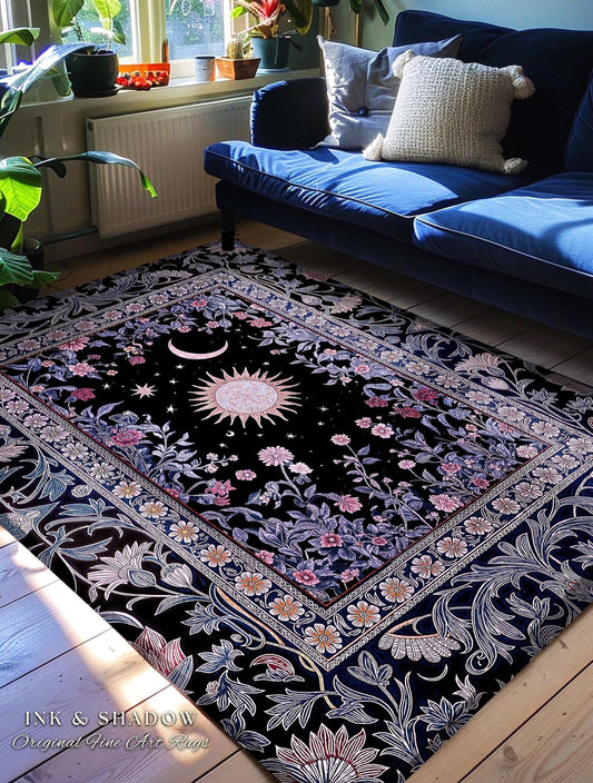 May include: Black area rug with a celestial design featuring a sun, moon, and stars. The rug has a floral border with pink and white flowers. The text "INK & SHADOW Original Fine Art Rugs" is visible in the bottom left corner.