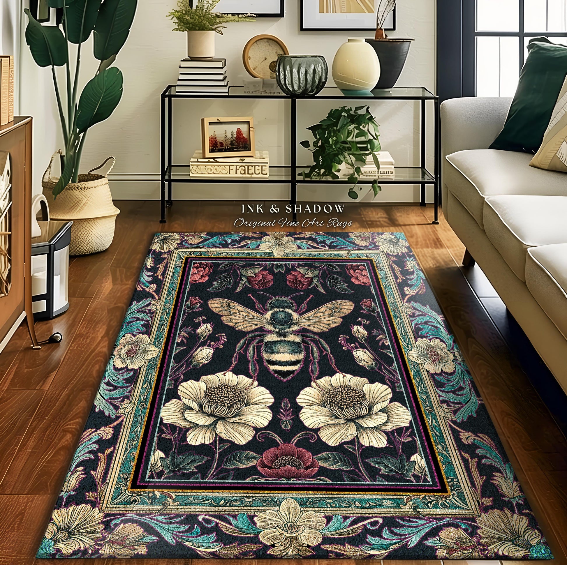 May include: A black and teal rug with a floral design and a bee in the center. The rug has a gold frame and the text "Ink & Shadow Original Fine Art Rugs" is printed at the top.