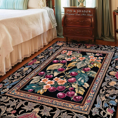 May include: A rectangular area rug with a black background and a floral and cherry design. The central image features a cherry branch with red cherries and pink flowers. The rug has a decorative border with floral patterns and the text "INK & SHADOW Original Fine Art Rugs".