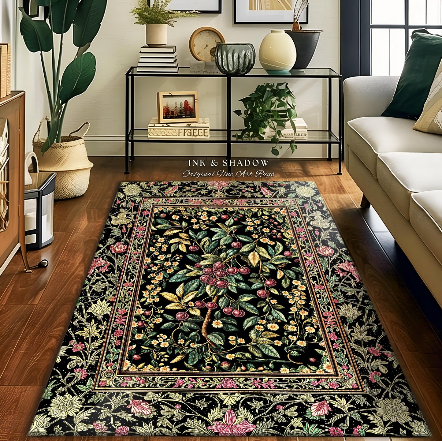 May include: A rectangular black rug with a floral and fruit tree design. The rug features a central tree with red cherries, surrounded by green leaves and yellow flowers. The border has pink and yellow floral patterns. The text "INK & SHADOW Original Fine Art Rugs" is visible.