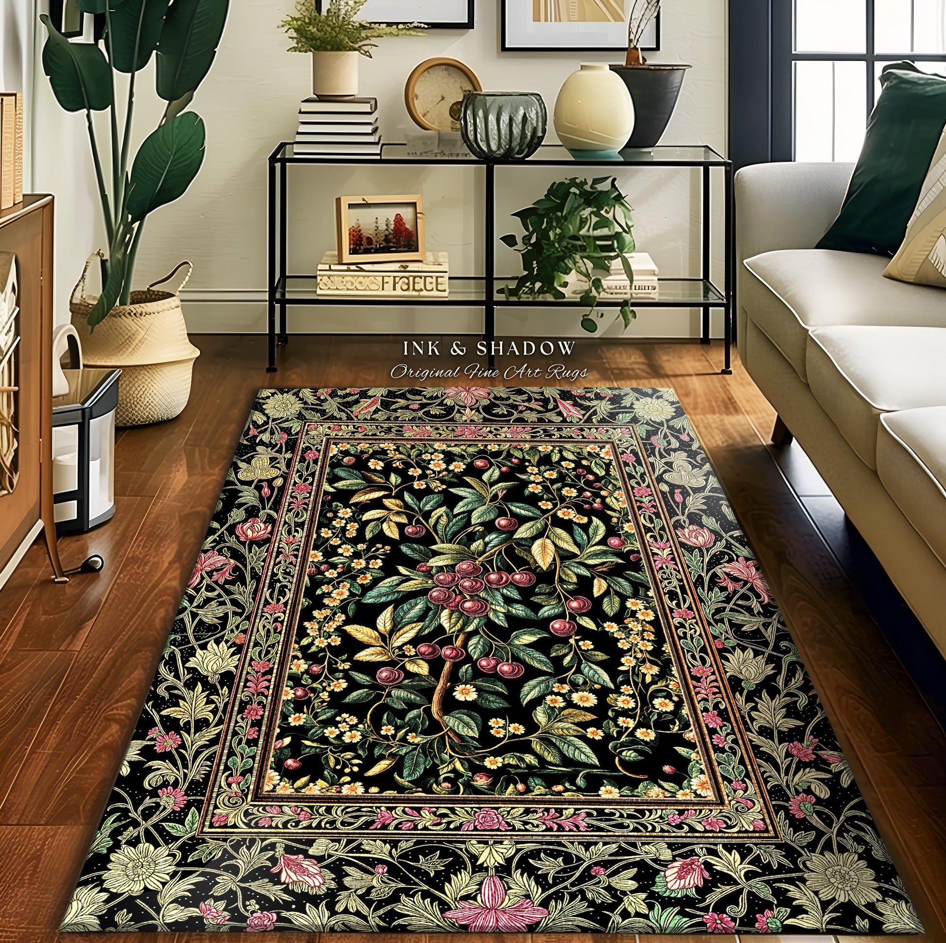 May include: A rectangular black rug with a floral and fruit tree design. The rug features a central tree with red cherries, surrounded by green leaves and yellow flowers. The border has pink and yellow floral patterns. The text "INK & SHADOW Original Fine Art Rugs" is visible.