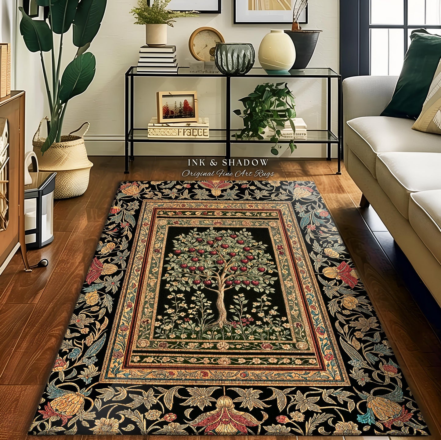 May include: A rectangular black rug with a central tree design laden with red fruit, framed by a detailed border of floral and leaf patterns. The rug features the text "INK & SHADOW Original Fine Art Rugs".