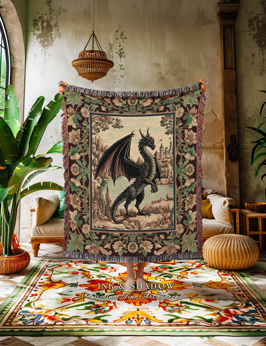 May include: A tapestry featuring a black dragon with outstretched wings, standing before a castle. The tapestry has a brown border with floral and leaf patterns, and a fringed edge. The text "INK & SHADOW Original Fine Art Throws" is visible at the bottom.