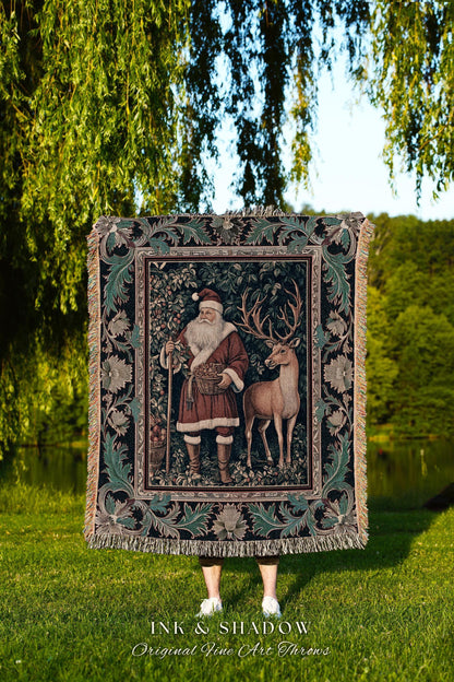 May include: A tapestry throw featuring Santa Claus and a deer in a forest scene. The throw has a dark background with a decorative border and fringe. The text "INK & SHADOW Original Fine Art Throws" is at the bottom.