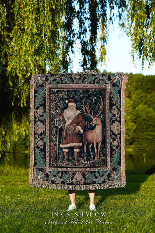 May include: A tapestry throw featuring Santa Claus and a deer in a forest scene. The throw has a dark background with a decorative border and fringe. The text "INK & SHADOW Original Fine Art Throws" is at the bottom.