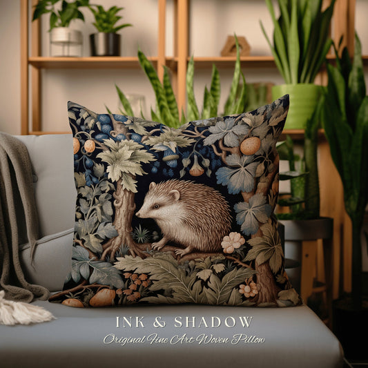 May include: A decorative pillow featuring a woven tapestry design of a hedgehog in a forest setting. The pillow has a dark blue background with green, brown, and blue foliage. The text "INK & SHADOW Original Fine Art Woven Pillow" is printed below the image.