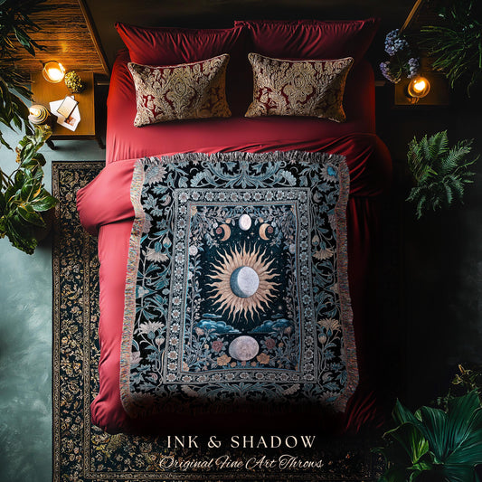 May include: A decorative throw blanket with a celestial design featuring a sun, moons, and floral elements. The blanket is displayed on a red bed with matching pillows. The text "INK & SHADOW Original Fine Art Throws" is visible at the bottom.