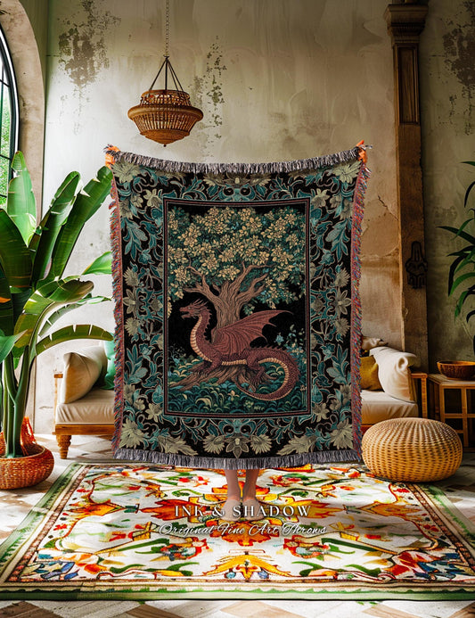 May include: A tapestry throw blanket featuring a dragon and tree design. The dragon is a reddish-brown color, and the tree has green leaves. The border of the blanket has a floral pattern with fringe.