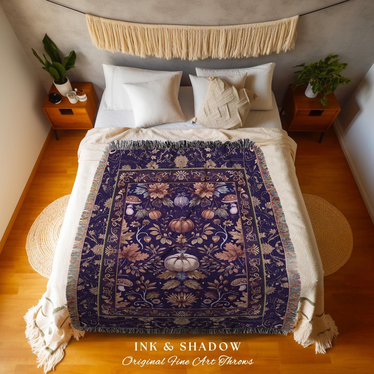 May include: A dark purple throw blanket with a floral and pumpkin design. The blanket has a fringed edge and is displayed on a bed. The text "INK & SHADOW Original Fine Art Throws" is at the bottom.
