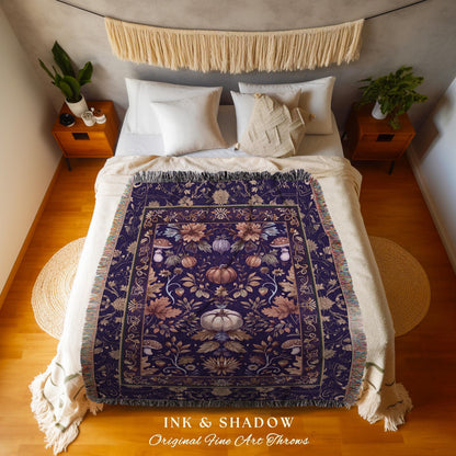 May include: A dark purple throw blanket with a floral and pumpkin design. The blanket has a fringed edge and is displayed on a bed. The text "INK & SHADOW Original Fine Art Throws" is at the bottom.