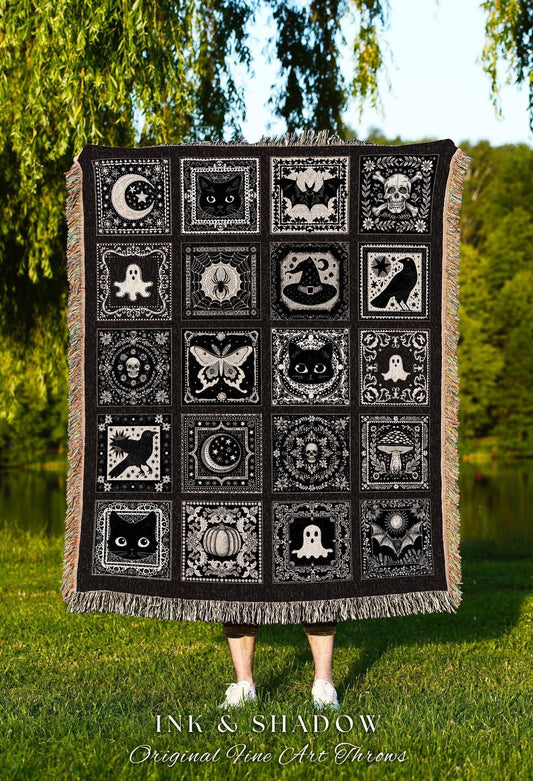 May include: Black and white throw blanket featuring a repeating pattern of spooky Halloween-themed images. The squares include a crescent moon, black cat, bat, skull, ghost, spiderweb, witch hat, raven, and butterfly. The blanket has a fringed edge.