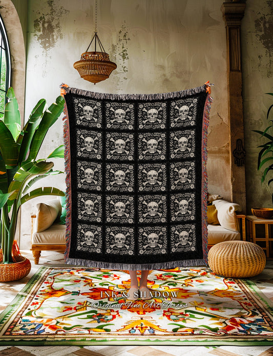 May include: Black woven throw blanket with a repeating pattern of white skulls and crossbones. The blanket has a fringe border and is draped over a couch in a room with a patterned rug. The text "INK & SHADOW Original Fine Art Throws" is visible at the bottom of the image.