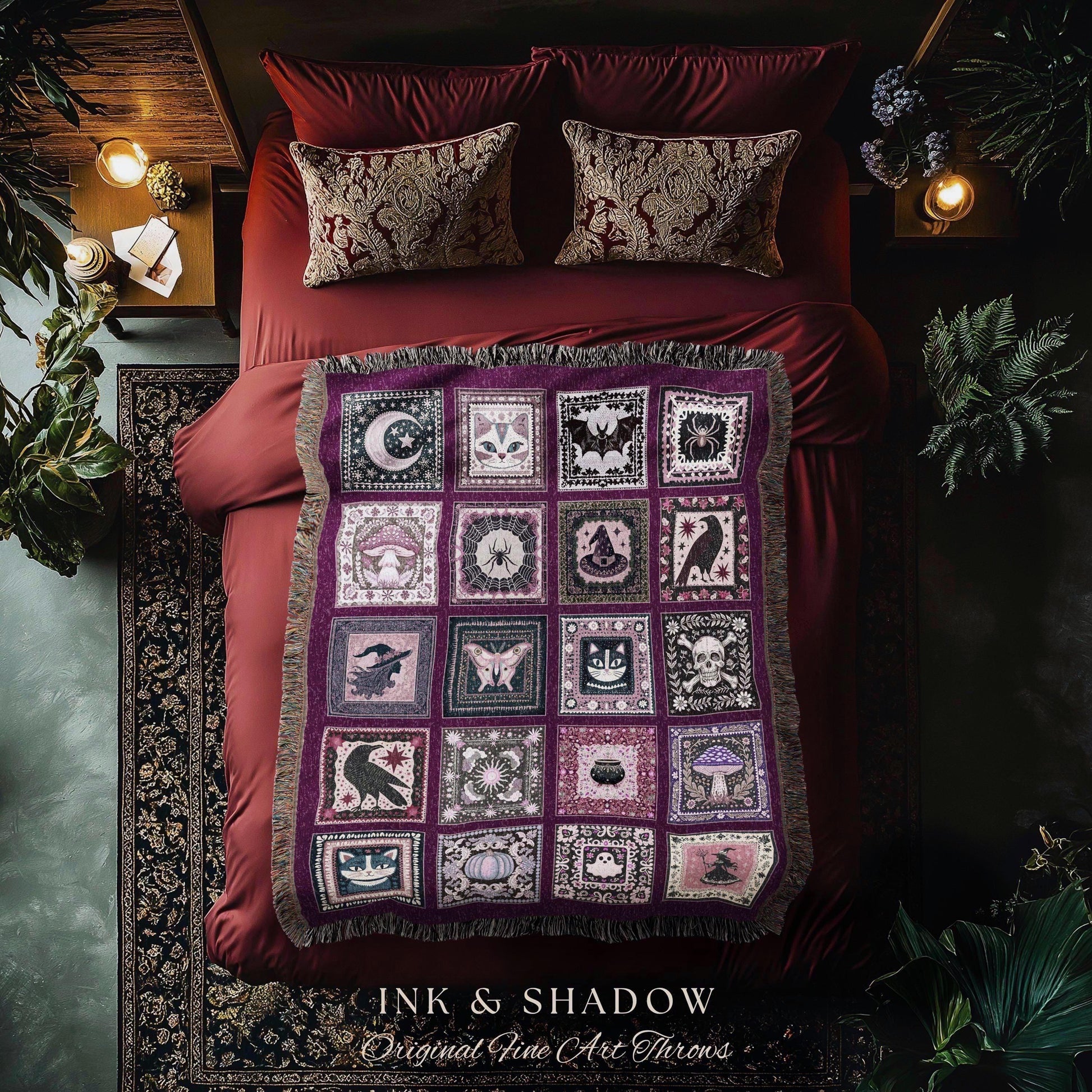 May include: A purple throw blanket with a patchwork design featuring various occult symbols like moons, bats, and skulls. The blanket is fringed and rests on a red bed with matching pillows. The text "INK & SHADOW Original Fine Art Throws" is at the bottom.