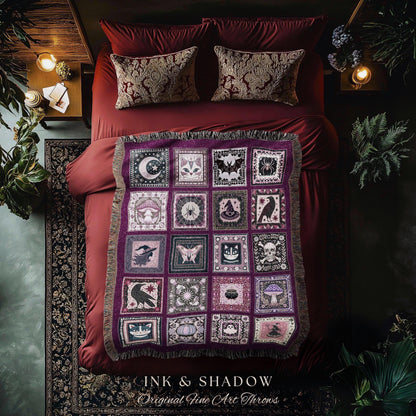 May include: A purple throw blanket with a patchwork design featuring various occult symbols like moons, bats, and skulls. The blanket is fringed and rests on a red bed with matching pillows. The text "INK & SHADOW Original Fine Art Throws" is at the bottom.