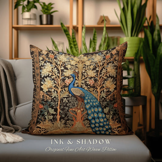 May include: A decorative throw pillow with a woven tapestry design featuring a peacock in a forest setting. The pillow is black with gold and blue accents. The text "INK & SHADOW Original Fine Art Woven Pillow" is printed on the bottom of the pillow.