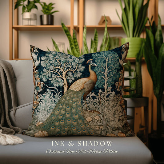May include: A decorative throw pillow with a peacock design in shades of blue, green, and gold. The pillow features a peacock with its tail feathers spread out, surrounded by intricate floral patterns. The text "INK & SHADOW Original Fine Art Woven Pillow" is printed on the bottom of the pillow.