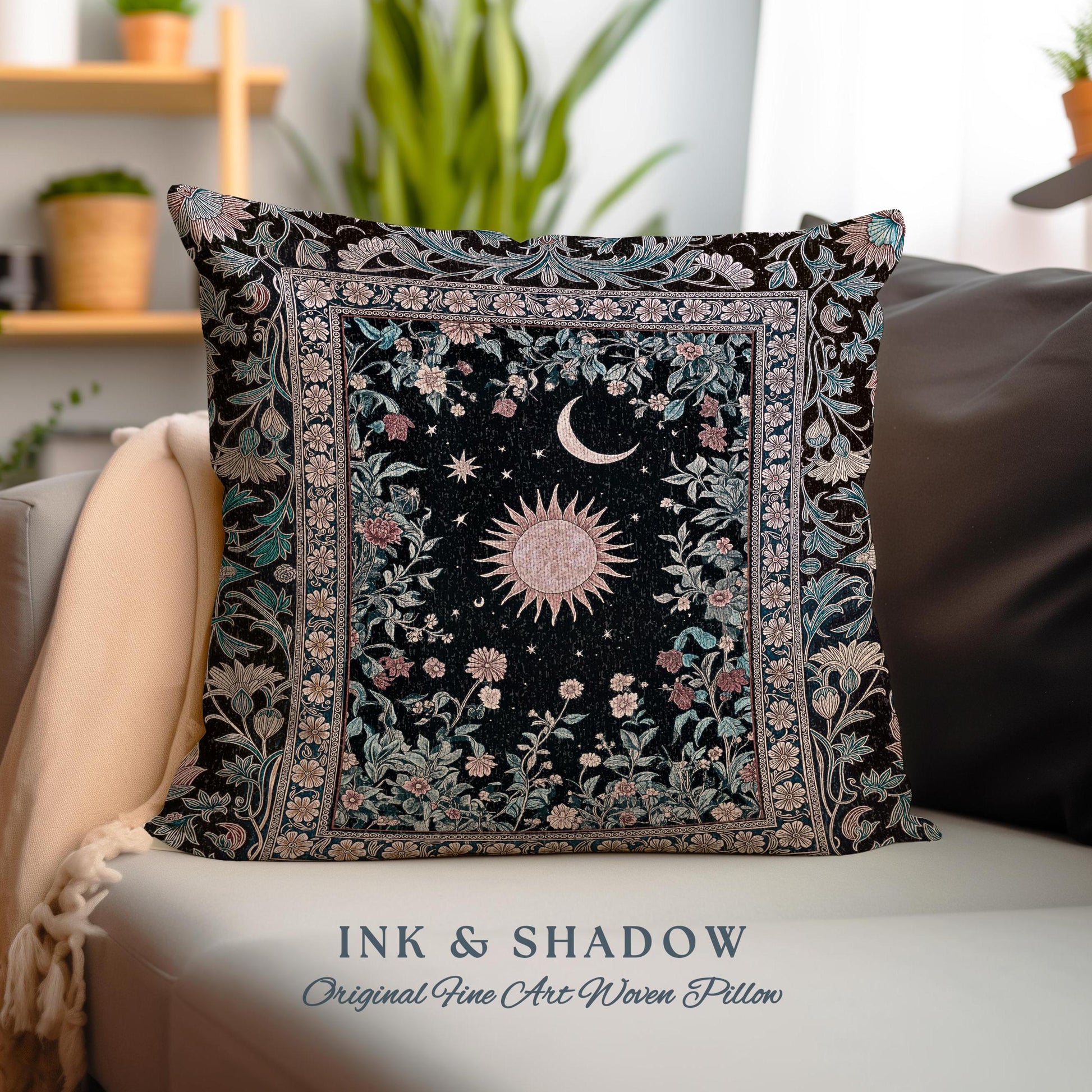 May include: A black woven pillow with a floral pattern and a sun and moon design in the center. The pillow has a border of intricate floral designs. The text "INK & SHADOW Original Fine Art Woven Pillow" is printed on the bottom of the image.