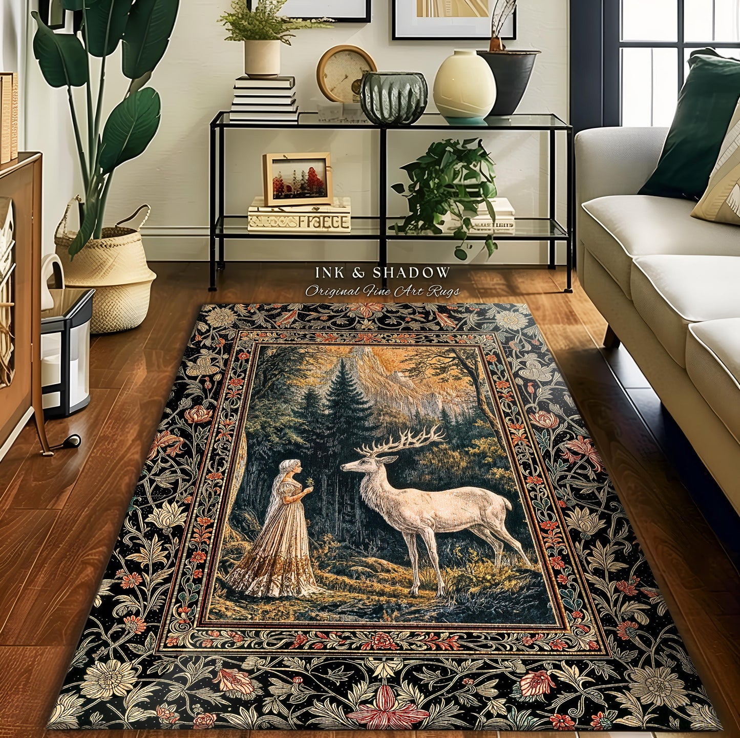 May include: A rectangular area rug with a detailed forest scene featuring a white deer and a woman in a long dress. The rug has a black border with floral and leaf patterns. The text "INK & SHADOW Original Fine Art Rugs" is visible.