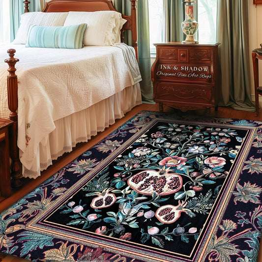 May include: A rectangular black rug with a floral and pomegranate design. The rug features a central motif of pomegranates and flowers in shades of pink, teal, and white. The border is a darker floral pattern. The text "INK & SHADOW Original Fine Art Rugs" is visible.