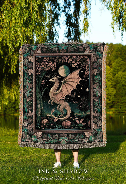 May include: A decorative throw blanket featuring a dragon illustration. The design includes a dragon, moon, stars, and pumpkins. The blanket has a black background with a floral border and fringe. The text "INK & SHADOW Original Fine Art Throws" is at the bottom.