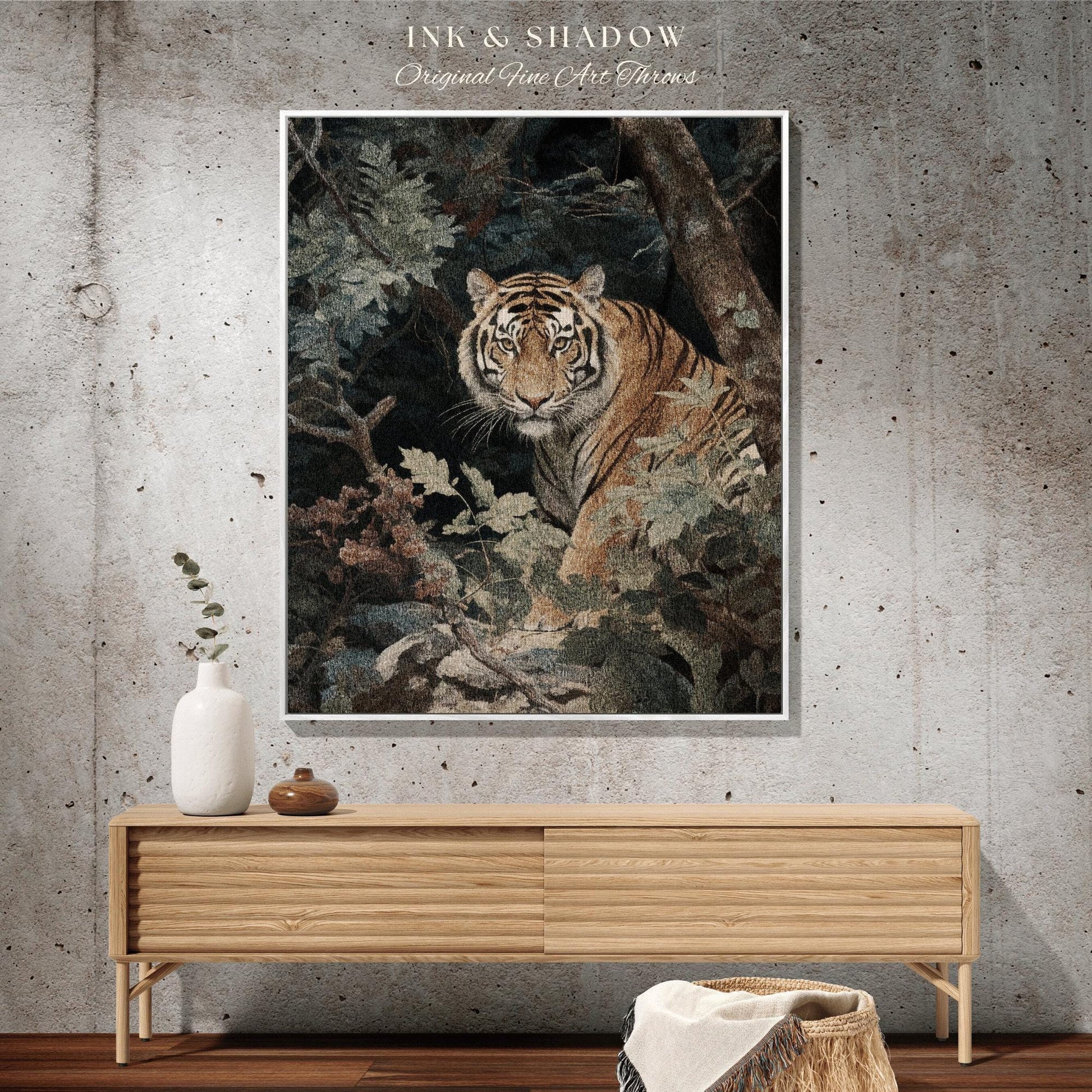 May include: A framed art print featuring a detailed illustration of a tiger amidst lush foliage. The tiger has orange and black stripes, with a focused gaze. The artwork is set against a backdrop of green and brown leaves and branches. The text "INK & SHADOW Original Fine Art Throws" is at the top.