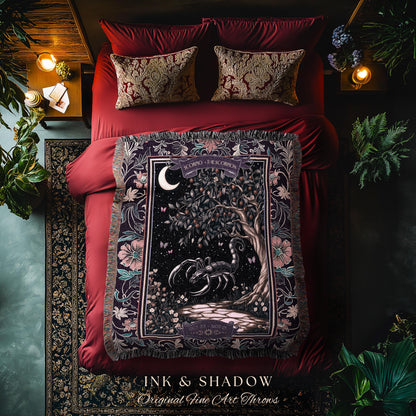 May include: A decorative throw blanket with a dark background featuring a scorpion, tree, and moon design. The blanket is draped over a red bed with matching pillows. The text "INK & SHADOW Original Fine Art Throws" is at the bottom.