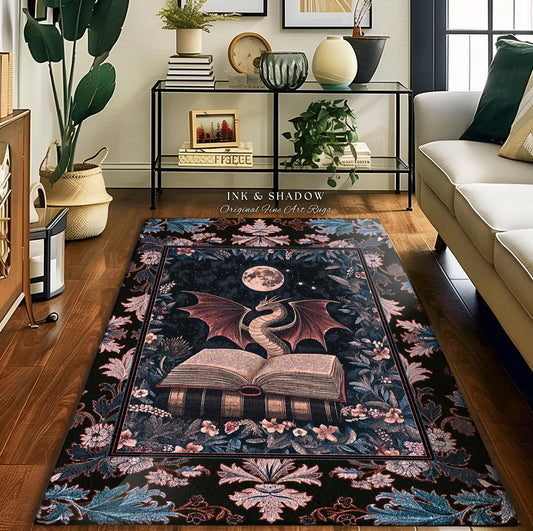 May include: A rectangular area rug with a dark background featuring a dragon, an open book, and a full moon. The dragon has red wings and is positioned above the book. The rug is framed with floral and leaf patterns. The text "INK & SHADOW Original Fine Art Rugs" is visible.