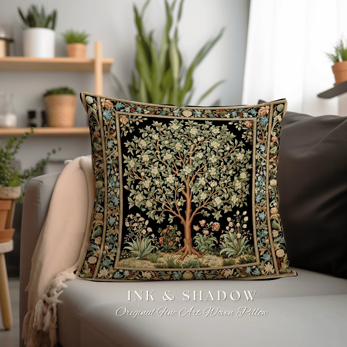 May include: A black and gold woven pillow featuring a detailed tapestry design of a tree with white flowers and green leaves. The pillow has a black background and a gold border. The text "INK & SHADOW Original Fine Art Woven Pillow" is printed below the pillow.