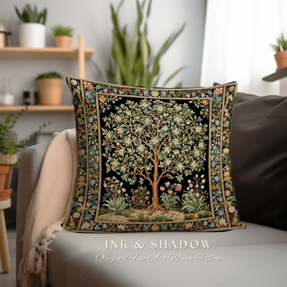 May include: A black and gold woven pillow featuring a detailed tapestry design of a tree with white flowers and green leaves. The pillow has a black background and a gold border. The text "INK & SHADOW Original Fine Art Woven Pillow" is printed below the pillow.